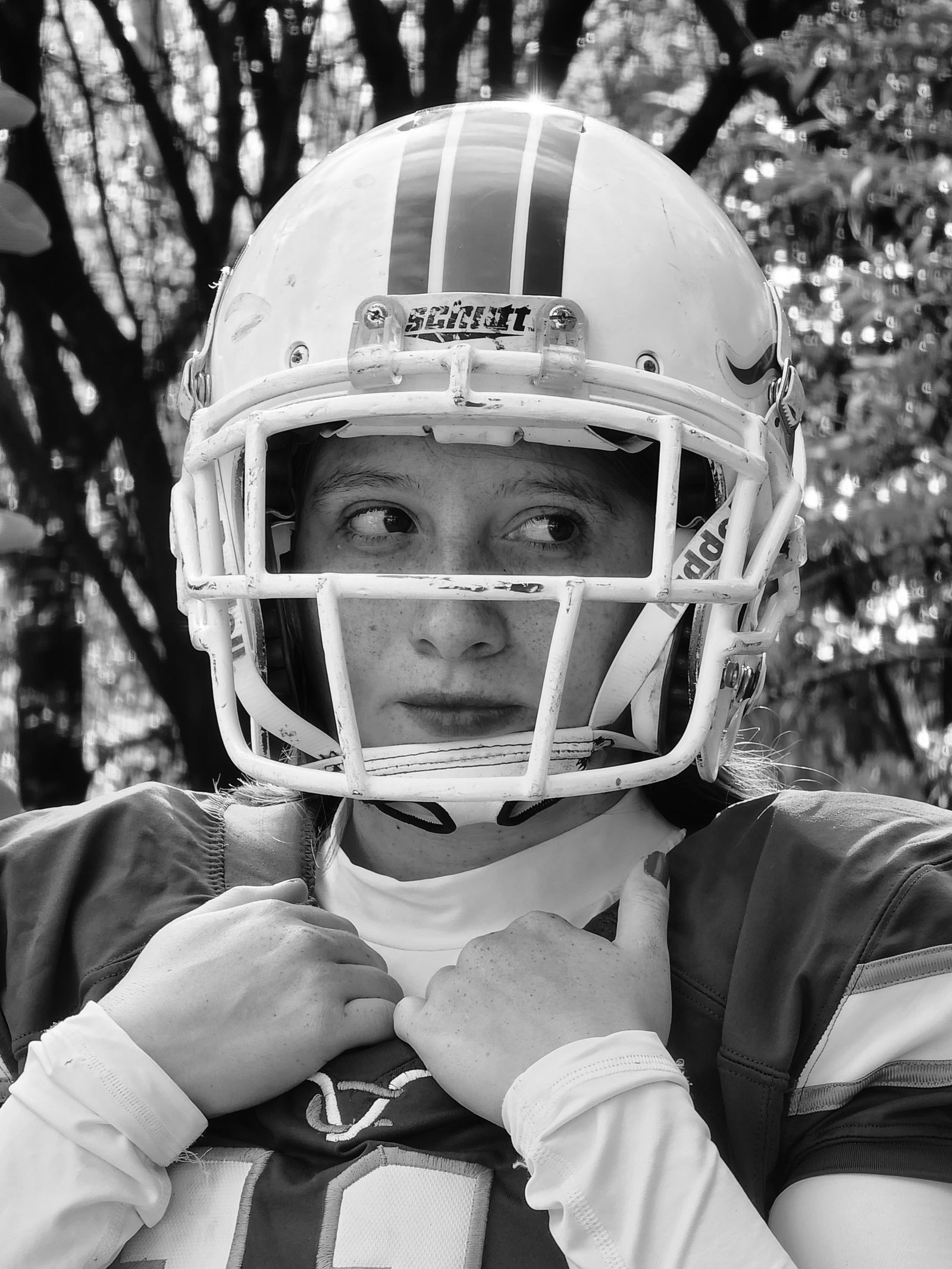 Black and white portrait of a football player wearing a helmet