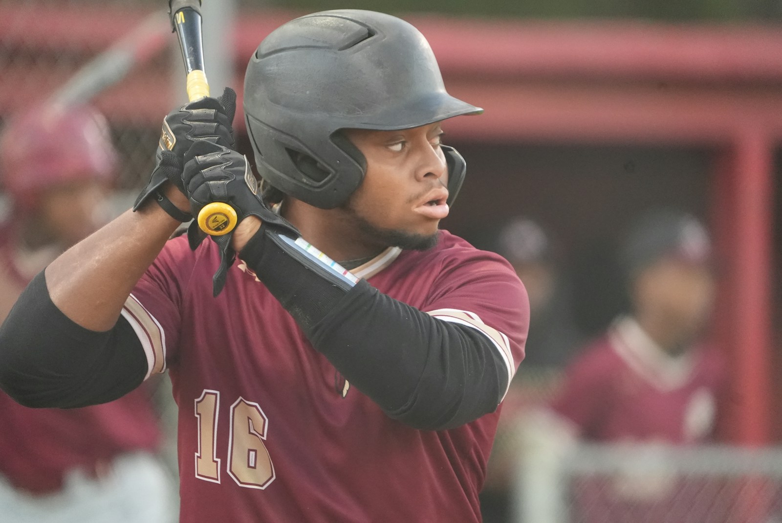 A baseball batter looking toward the pitcher